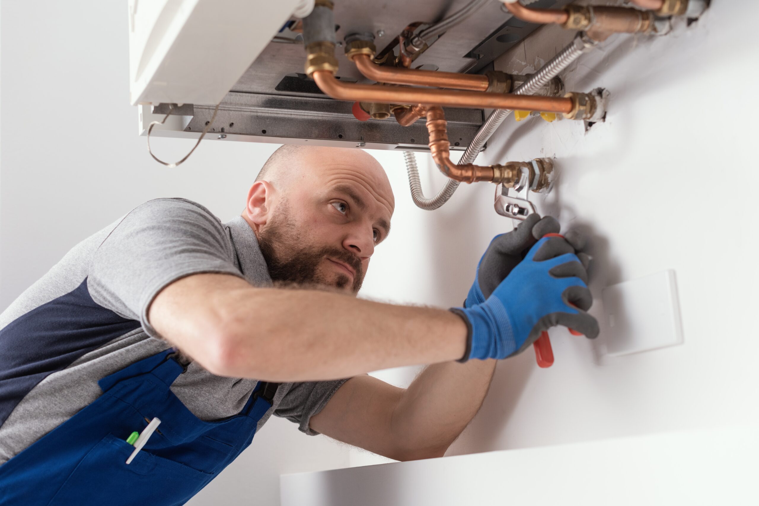 Llanw stock image of plumber fixing boiler